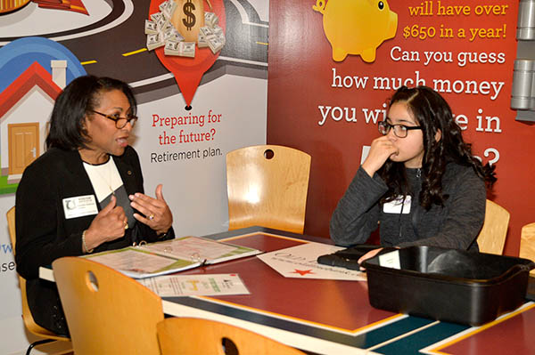Image of Grovetta Gardineer teaching students about money management at the Junior Achievement Finance Park in Landover, Md.